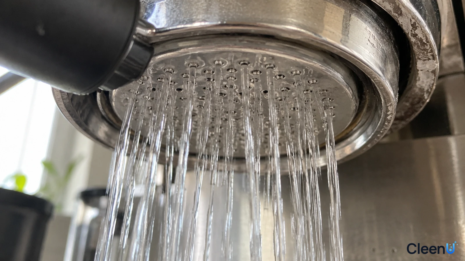 Illustration: Close-up of multiple streams of water flowing from a metal coffee machine shower screen.